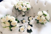 White rose and salal foliage wedding collection including 1 x bridal bouquet, 2 x bridesmaid bouquets and 6 x buttonholes. 