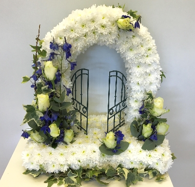 Blue gates of heaven funeral tribute with ivy foliage edge. 
