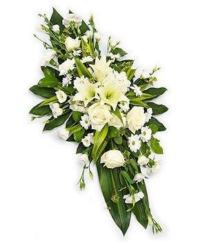 All white double ended casket spray including roses, germini and chrysanthemum. 
