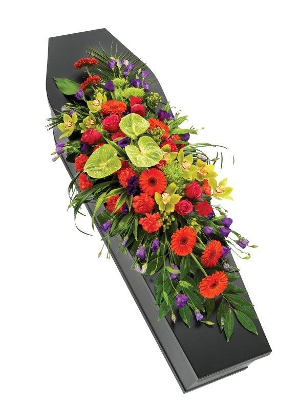 Mixed modern orange and purple casket spray including rose and orchid. 