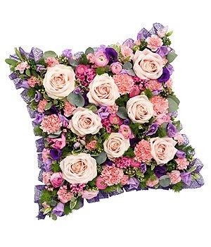 Pink, mauve and lilac mixed cushion funeral tribute including roses, carnation and lisianthus. 