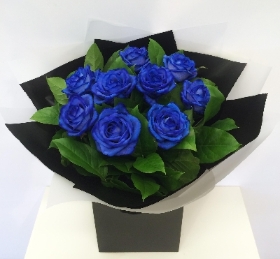 Bright blue roses in a striking bouquet. 