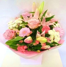 Pastel pink mixed bouquet including roses, lily and carnation. 