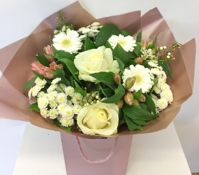 Beautiful bouquet in whites and light pink tones with rose gold wrap and gift bag. 