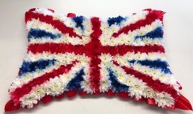 Union Jack funeral tribute made using red, white and blue sprayed chrysanthemum. 