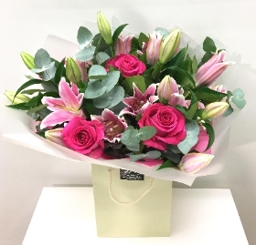 Hand tied of pink lily and rose, finished with scented eucalyptus. 