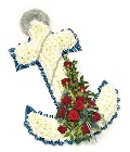 Anchor funeral tribute made with white chrysanthemum and finished with blue ribbon and red focal flowers. 