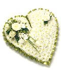 Classic massed heart funeral tribute including chrysanthemum and other seasonal flowers. 
