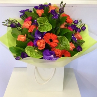 Hand tied bouquet in the secondary colour palette including anthuriums, orchids, roses and more. 