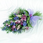 Pink and purple flat bouquet including lily, roses and lizianthus. 