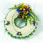 Massed wreath with bright coloured focal flowers. 